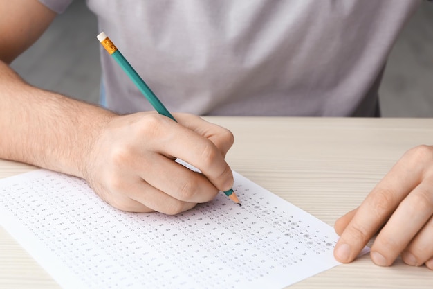 Male student passing exam closeup