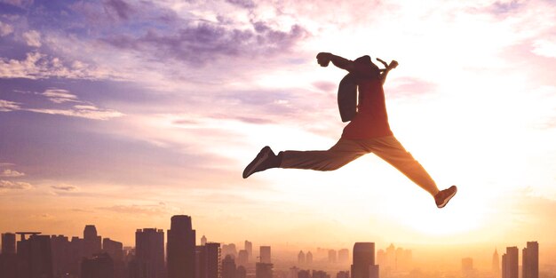 Male student running fast with dawn sky background