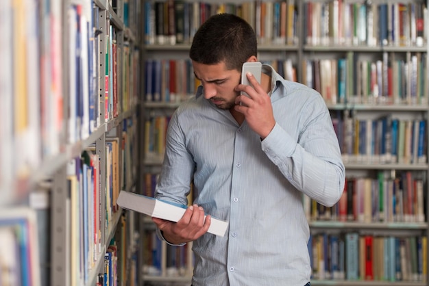 Male Student Talking On The Phone In Library  Shallow Depth Of Field