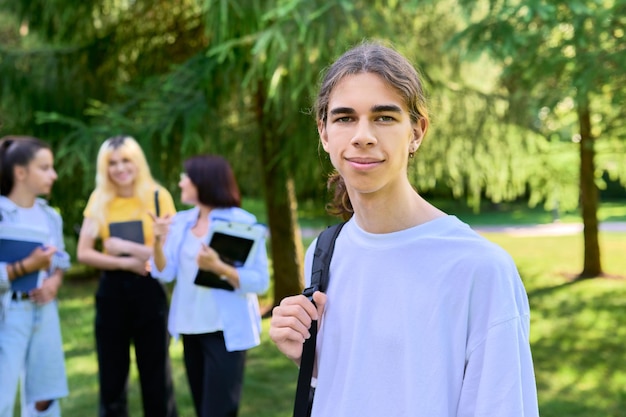Male student   years old with backpack in school park