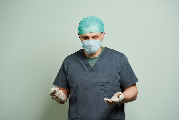 male surgeon is holding a scalpel