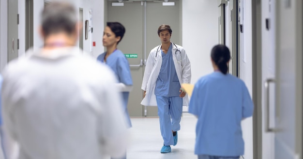 male surgeon walking in corridor at hospital