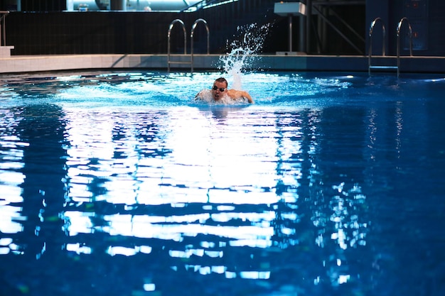 Male swimmer at the swimming pool Underwater photo