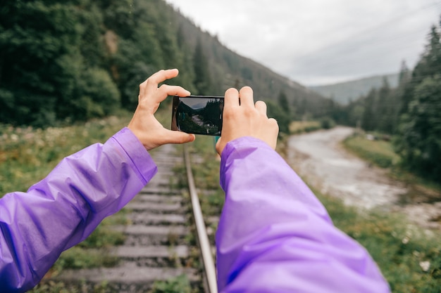 male taking photo of nature landscape