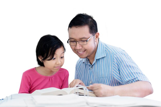 Male teacher guides his student to reading a book