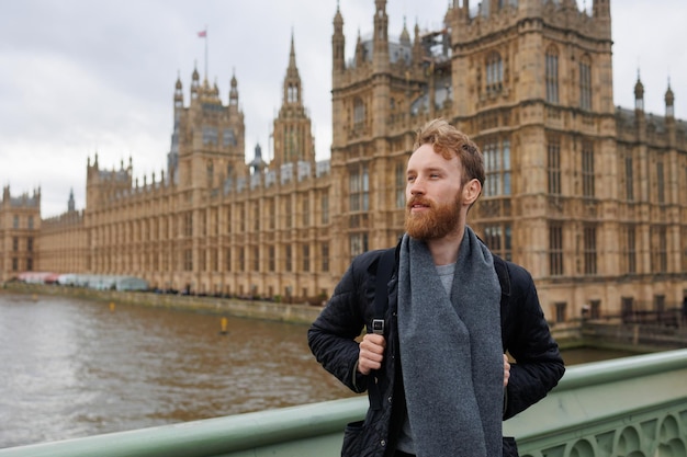 male tourist in front of london landmarks