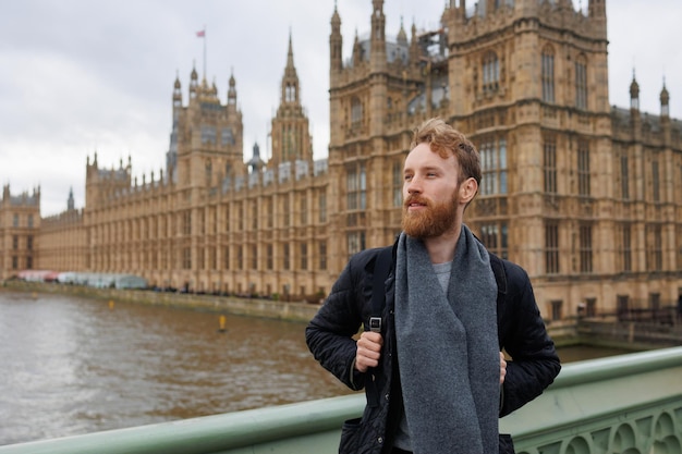 Male tourist in front of London landmarks