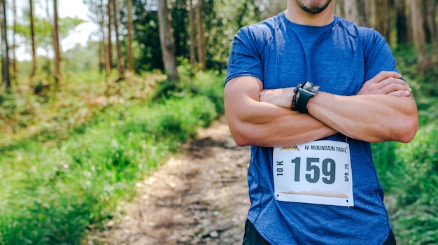 Male trail athlete posing with race number