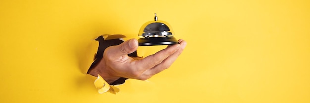 Male traveler hand bell to call