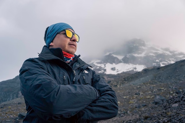 Male traveler in the winter in the mountains closeup