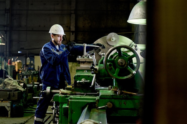 Male turner using lathe