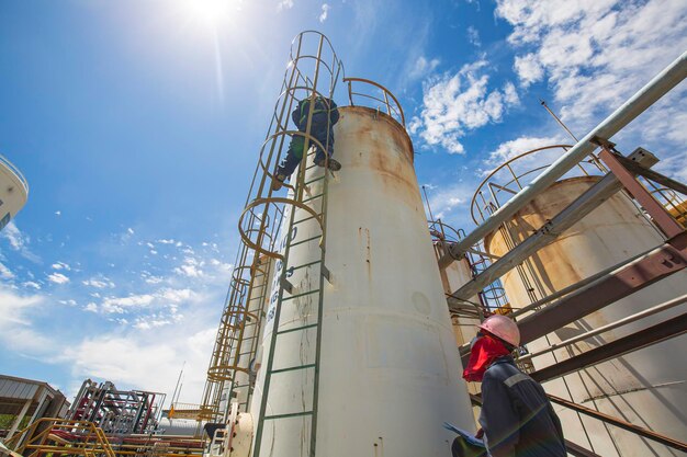 Male two worker up the ladder is for inspection ultrasonic thickness shell plate top of storage tank