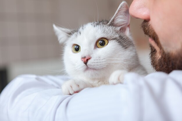 Male vet with a cat at his clinic