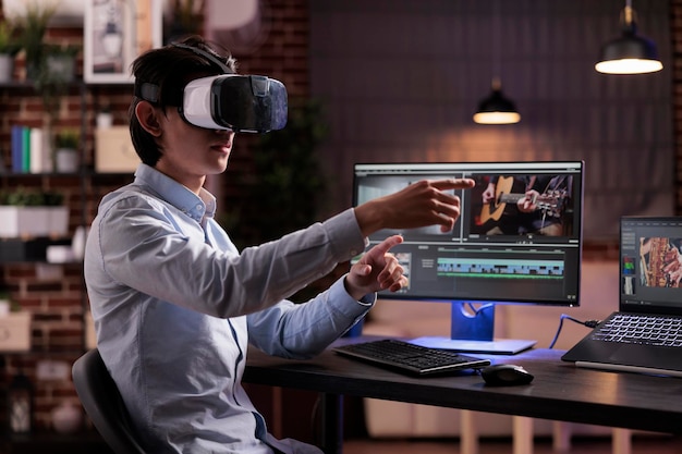 Photo male videographer editing movie montage with virtual reality glasses, using multimedia production software to create footage. edit with color grading and visual effects, working with vr goggles.