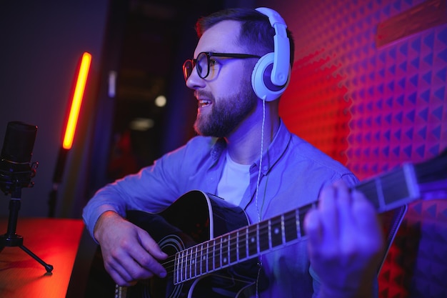 male vlogger recording music related broadcast at studio