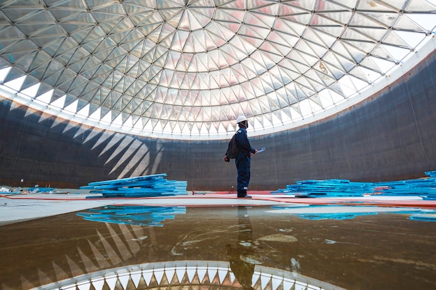 Male worker file record visual inspection tank into the confined space is the lighting roof dome