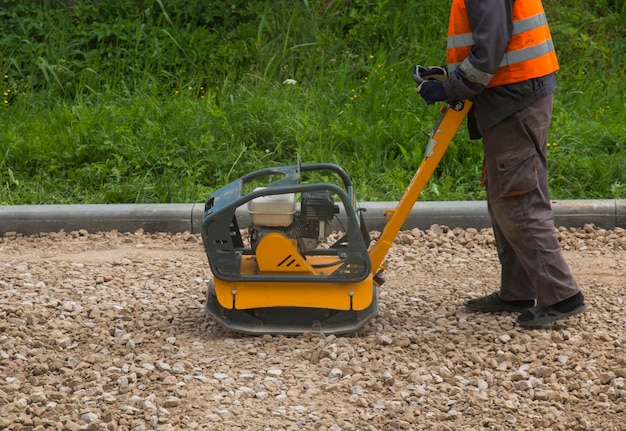 Male worker grabbing gravel road