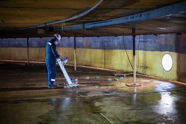 Male worker inspection floorscan tank