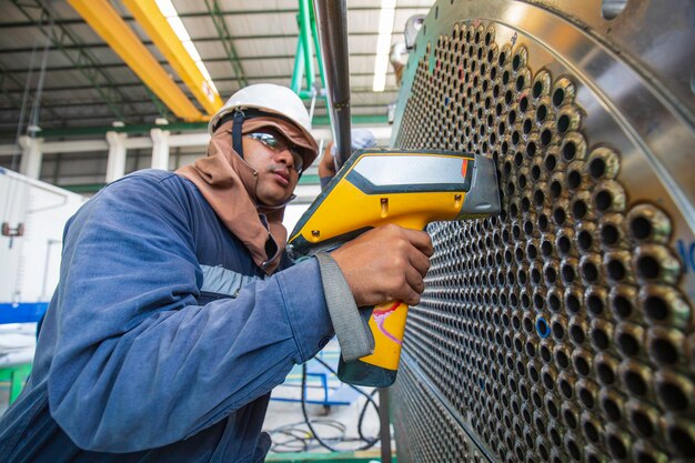 Photo male worker inspection weld of heat exchanger tube positive material