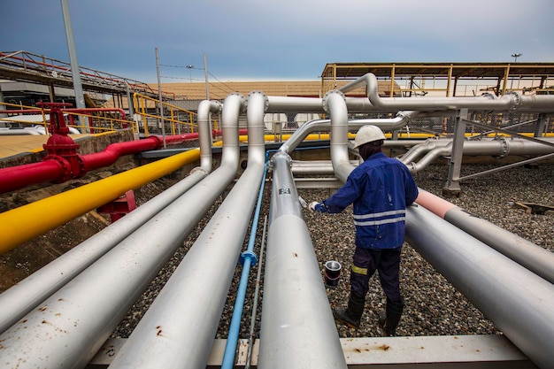 Male worker painted gray at pipeline oil