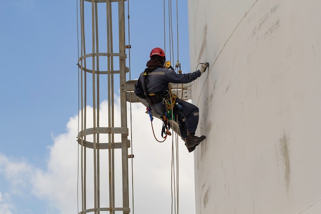 Male worker rope access height safety inspection of thickness
storage oil and gas tank industry