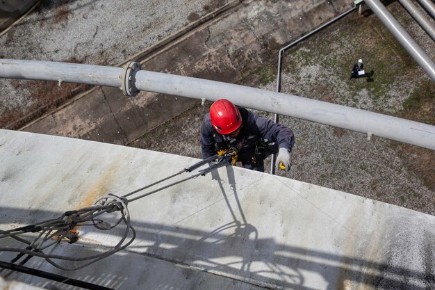 Male worker rope access height safety inspection of thickness
storage oil and gas tank industry