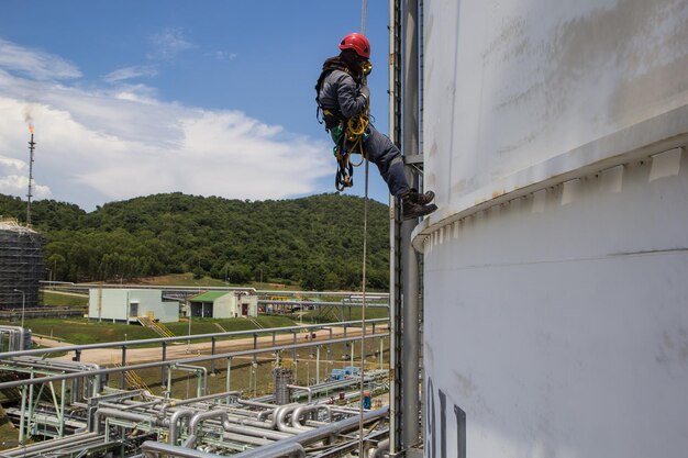 Male worker rope access  inspection of thickness cold tank industry