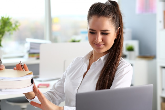 Male worker show pack of papers to busy beautiful female