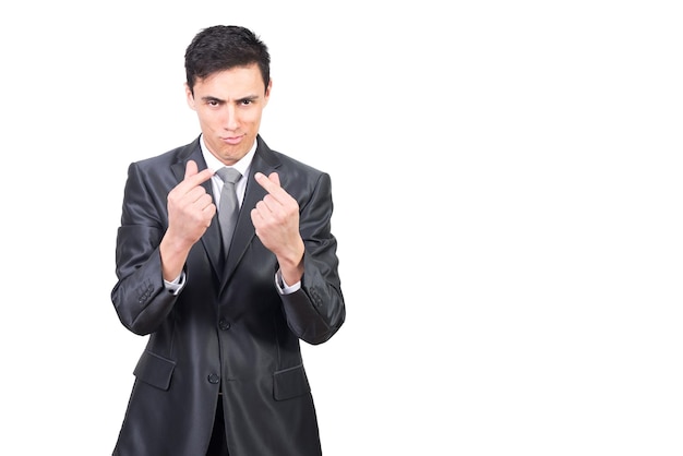 Male worker in suit smirking and making money gesture and asking for payment for work in studio against white background