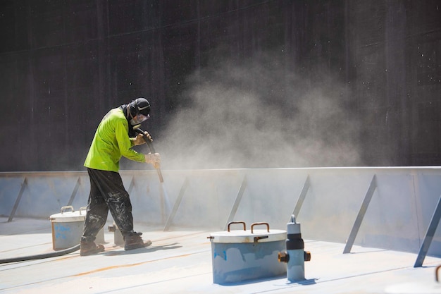 Male worker surface corrosion plate preparation by sand blasting of tank top deck pontoon