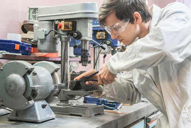 male worker use grindstone at the factory b