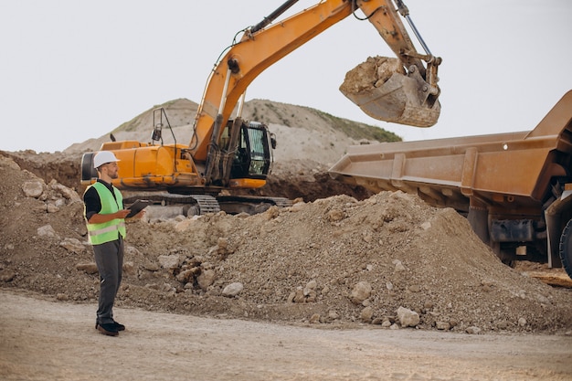 Male worker with bulldozer in sand quarry