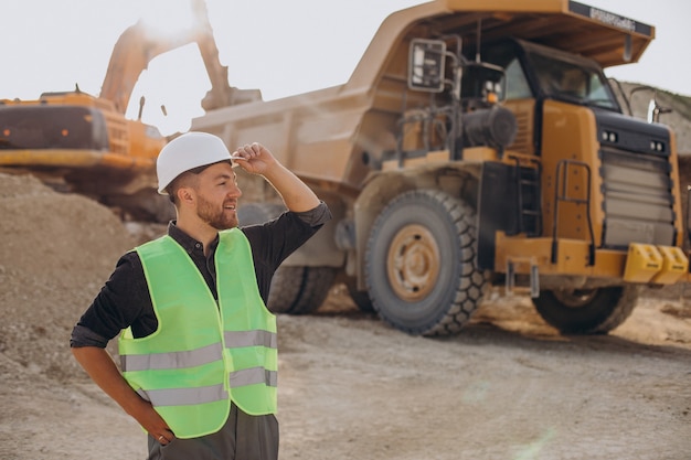 Male worker with bulldozer in sand quarry