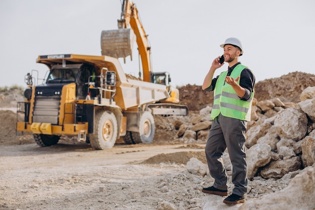 Male worker with bulldozer in sand quarry