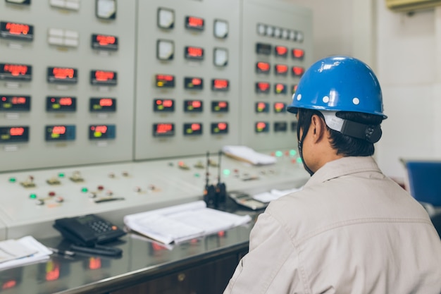 Male workers in the factory monitoring room in the meter