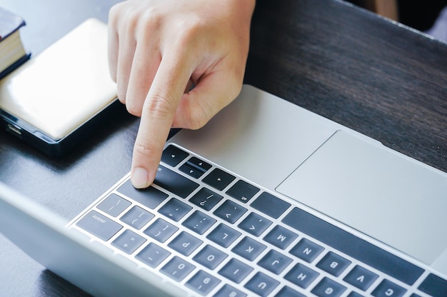 Male working with Laptop computer on the table