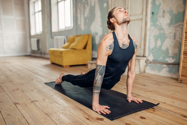 Male yoga doing push up exercise