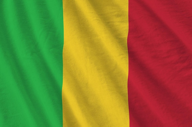 Mali flag with big folds waving close up under the studio light indoors The official symbols and colors in banner