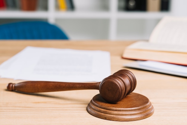 Mallet on gavel over wooden table in courtroom