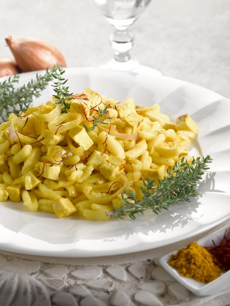 Malloreddus pasta with mozzarella onions and saffron