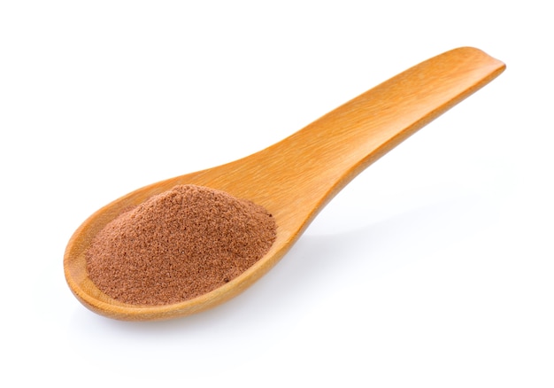 malt extract in wood spoon on white background