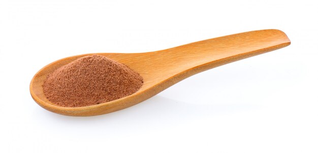 Malt extract in wood spoon on white isolated