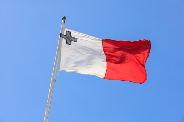 Malta flag malta flag on a pole waving on blue sky background