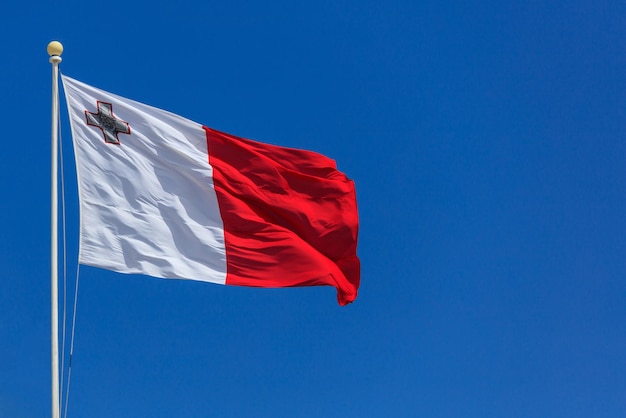 Malta flag malta flag on a pole waving on blue sky background