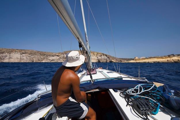 Malta,  Gozo Island, view of the southern rocky coast of the island at Xlendi Bay from a sailing boat