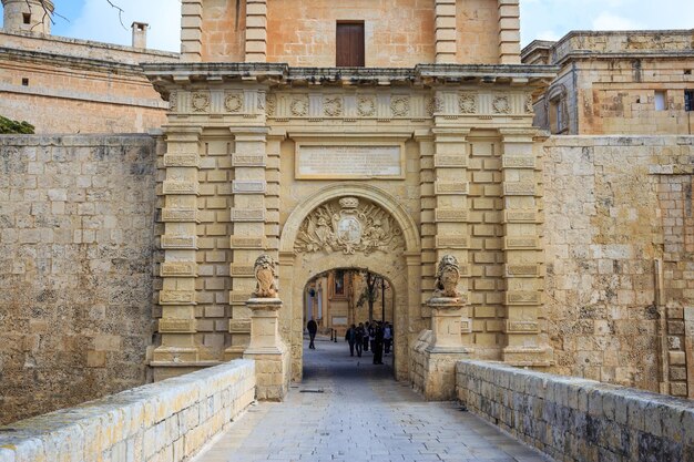 Malta Mdina toegangspoort Toeristen steken de voetgangersbrug over om de historische vestingstad te bezoeken