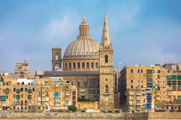 Malta, Valletta, traditional house building facade and basilica of Our Lady of Mount Carmel 