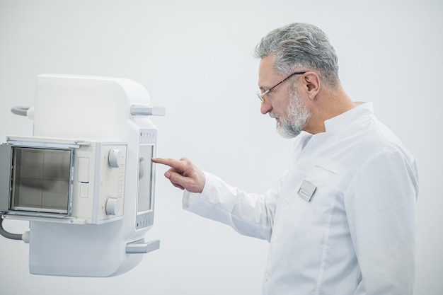 Mammography Male doctor getting the equipment ready for mammography