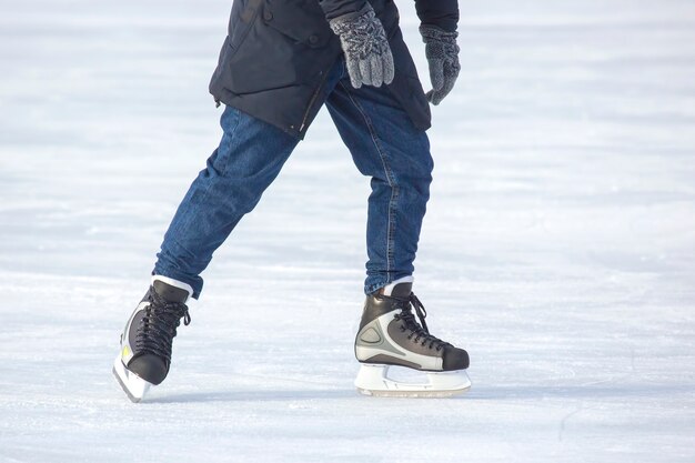 Man actively skates on an ice rink.