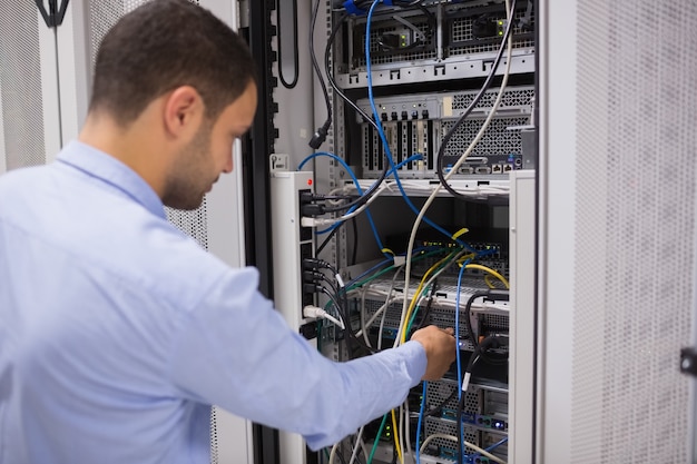 Man adjusting servers